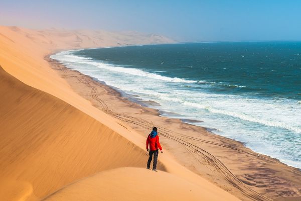 Person standing on sand dune
