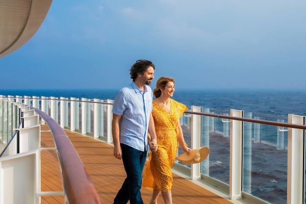 Couple walking on top deck of ship