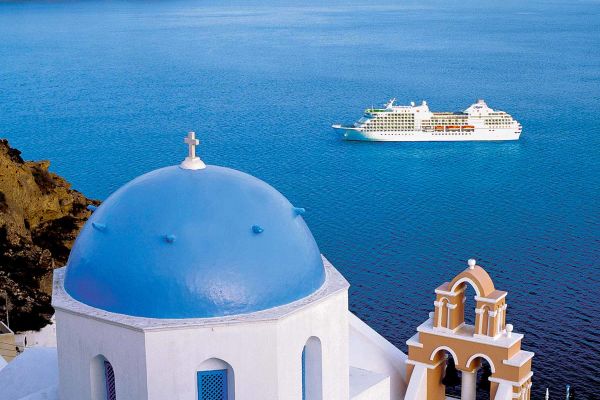 Cruise ship in Santorini. White buildings with blue dome roofs