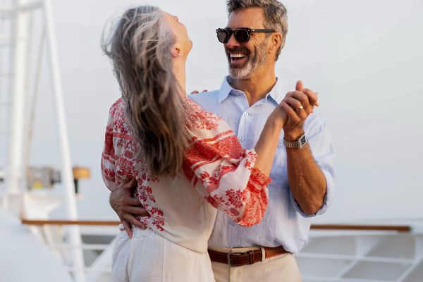 Couple dancing on top deck of ship