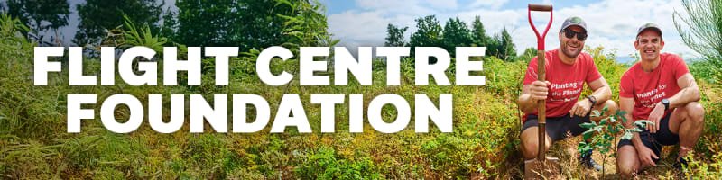 Flight Centre Foundations | two flight centre staff kneeling planting trees