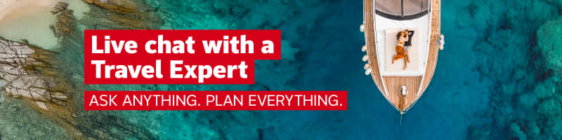 Live chat with a Travel Expert - ask anything, plan everything | Top down shot of a couple lying down, hugging on the deck of a sailboat