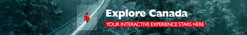 Explore Canada - Your interactive experience starts here. Person in red coat walking across a rope bridge in a snowy forest