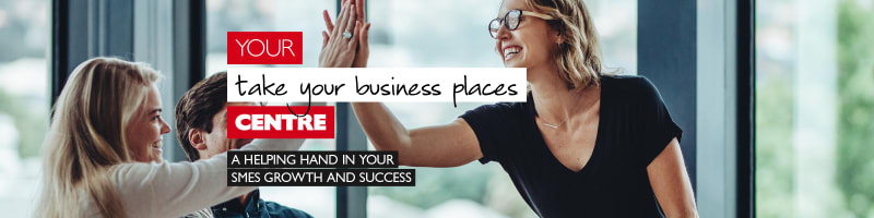 Your take your business places centre - A helping hand in your SMEs growth and success. Businesswomen high-fiving in a meeting room