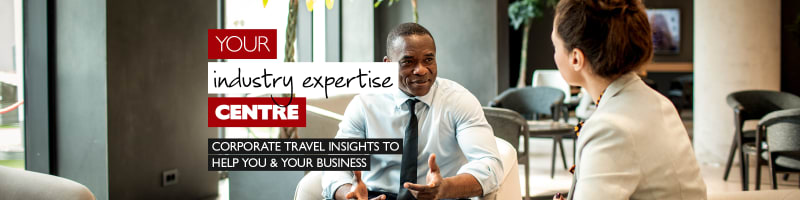 Your industry expertise centre - corporate travel insights to help you & your business. Black businessman and white businesswoman having a meeting over coffee