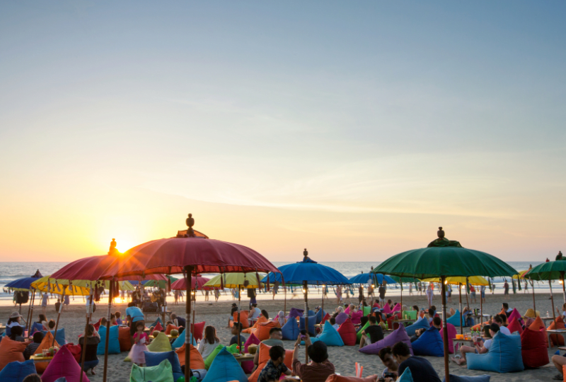 Sunset over beach diners on Seminyak Beach, Bali